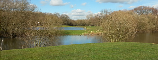1st Tee at Hersham Golf Club from across the lakes at the 8th